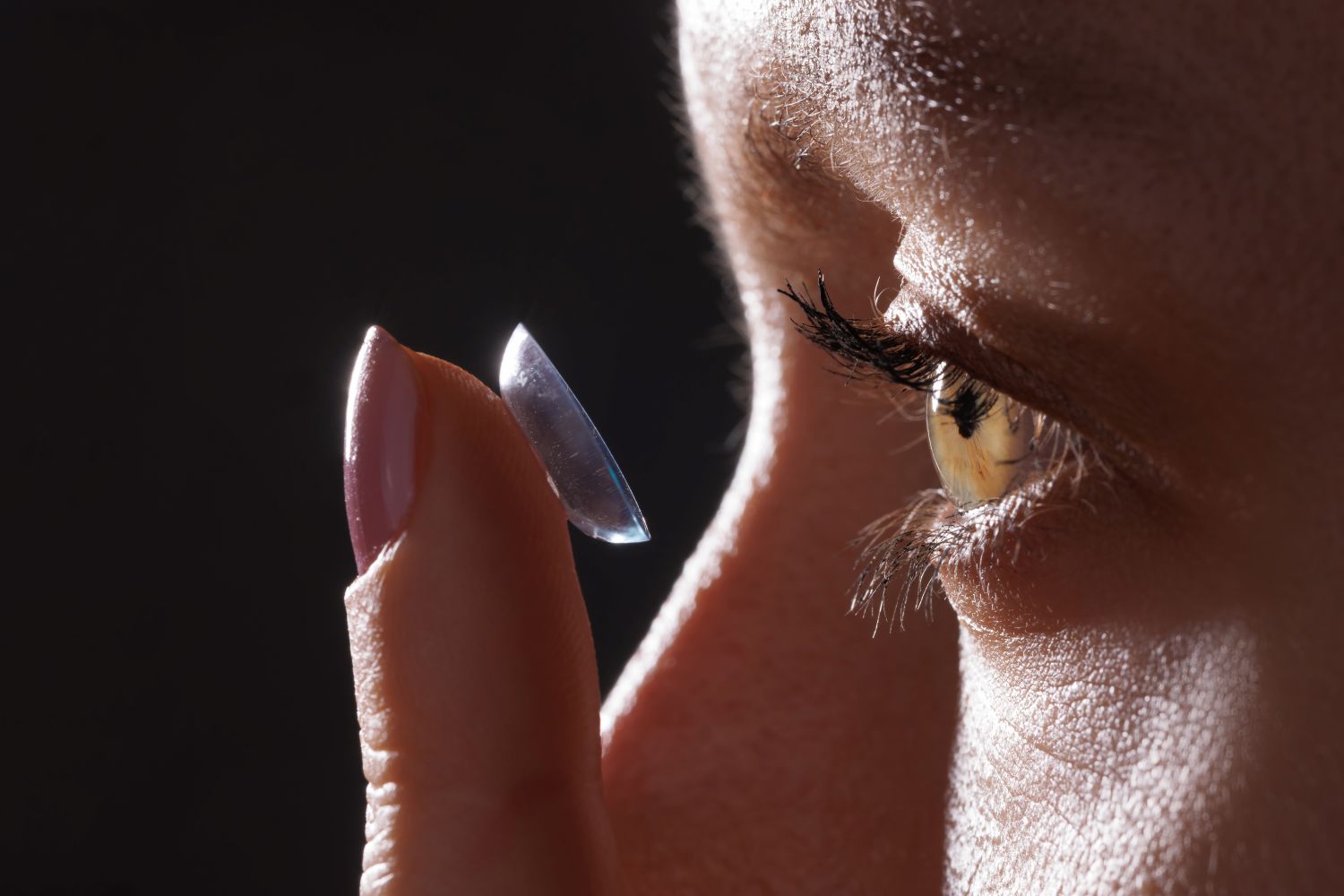 woman putting in contact lens
